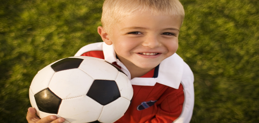 Little boy holding a football
